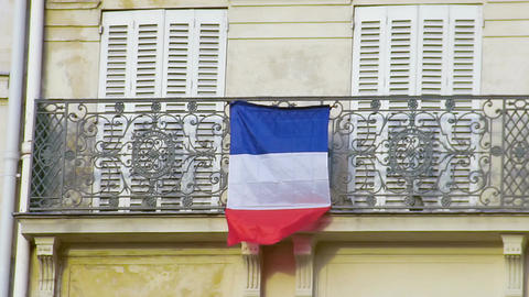 French flag waving in wind on balcony, love for motherland, patriotic feelings