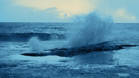 Surf Wave Crashing on Coastal Rocks. Tinted. Slow Motion