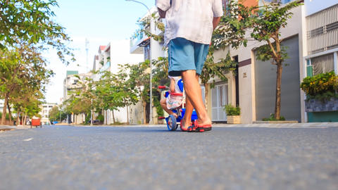 Backside Grandpa Pushes Tricycle with Girl Reads Ipod