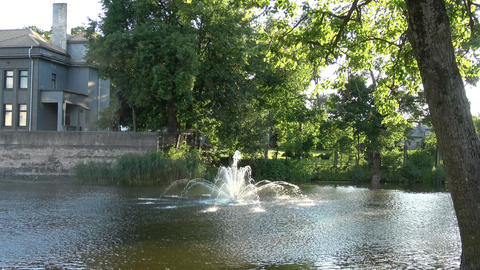 Working decorative fountain on river water