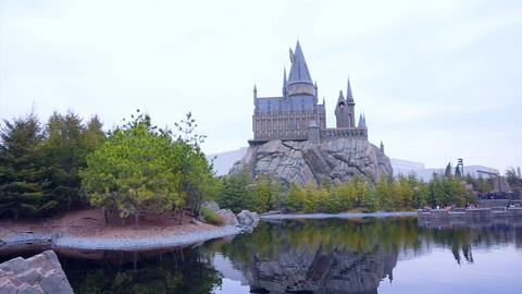 OSAKA, JAPAN - March 2015: The Hogwarts castle reflect in amusement park lake in