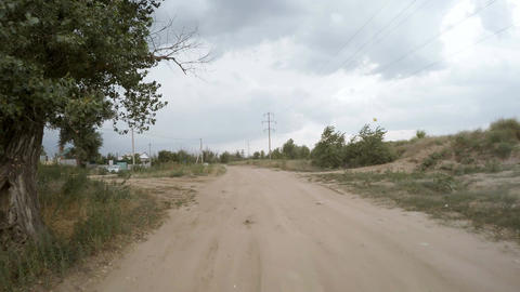 Rear view of car driving along a rural dirt road