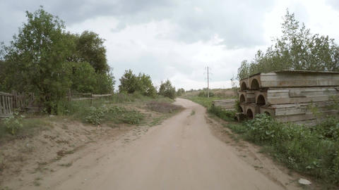 Rear view of car driving along a rural dirt road