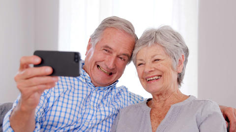 Senior couple taking selfie