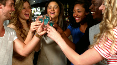 Cute friends having blue shots