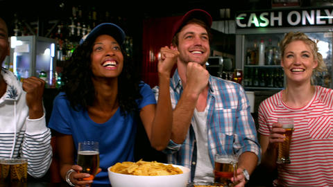 Friends watching tv and having a drink