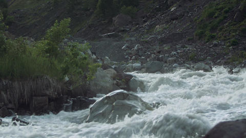 Rabid mountain stream stony rapids water flow with white splashes