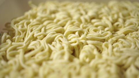 Adding hot water to instant noodles. Macro dolly shot
