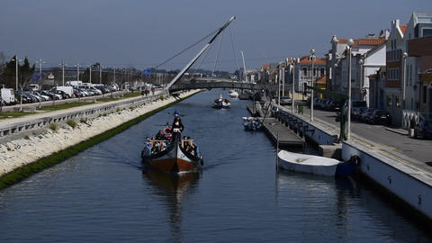 Tourists on Moliceiro traditional canal boats in Aveiro Portugal