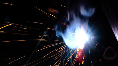 Welder working in industry with welding machine