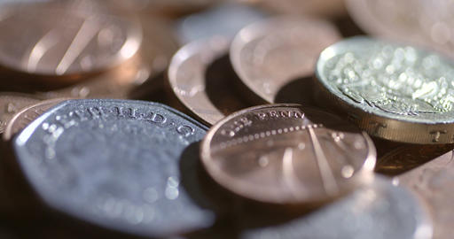 Harshly lit shot of rotating coins