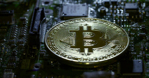 Reveal shot of a Casascius bitcoin on a shadowy circuit board