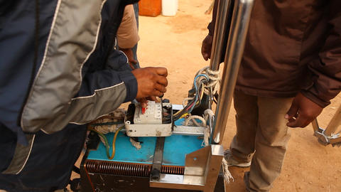 Electrician Works On Equipment