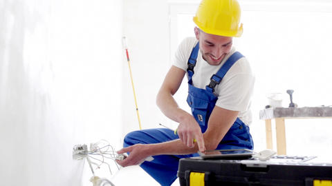 smiling builder with tablet pc and equipment