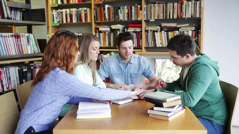 students with books preparing to exam in library