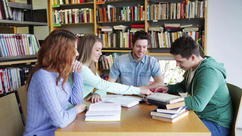 students with books preparing to exam in library