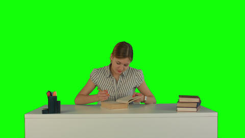 Beautiful female student read book on a Green Screen