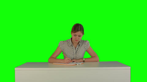 Young girl sitting in classroom at lecture and listening teacher on a Green