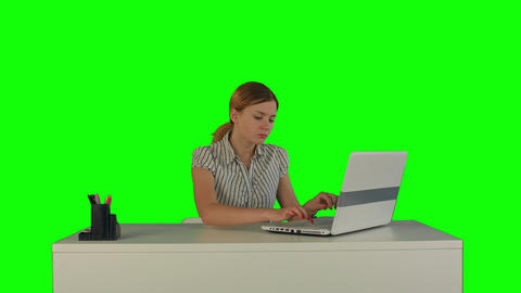 Businesswoman working on laptop on a Green Screen