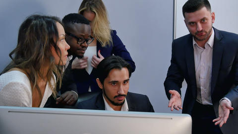 Team of happy business people posing for photographer around the desk