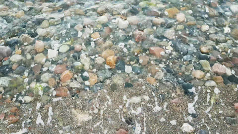 Waves on the beach with stones