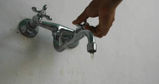 Dirty tap water Hand is opening faucet