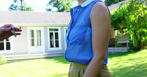 Close up of man giving house's keys to smiling woman