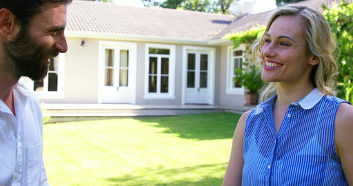 Man giving the house's keys to a smiling woman