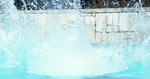 Handsome man doing a somersault on pool
