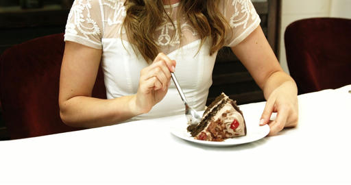 Business woman eating a chocolate cake