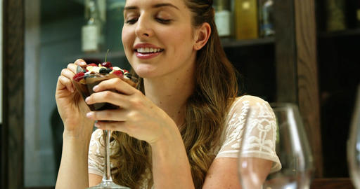 Business woman eating a desert