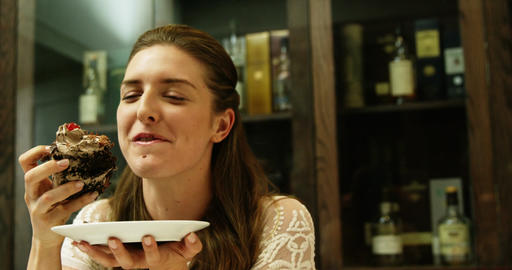 Business woman eating a chocolate cake
