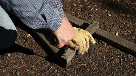 Man removes screw from wood