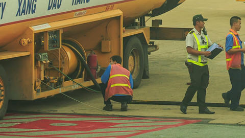 Airport Workers Check up Documents at Fuel Tanker