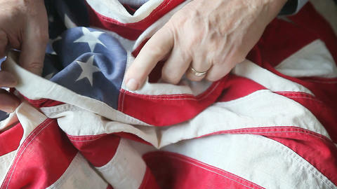 Man looking at very old American flag