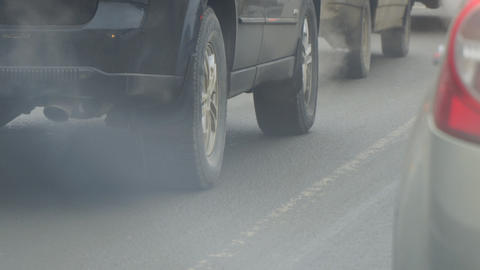 Cars in traffic. Exhaust fumes from exhaust pipe