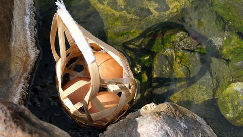 Boiled eggs with Round bamboo basket in hot spring and smoke at Chaeson National Park, Mueang Pan,