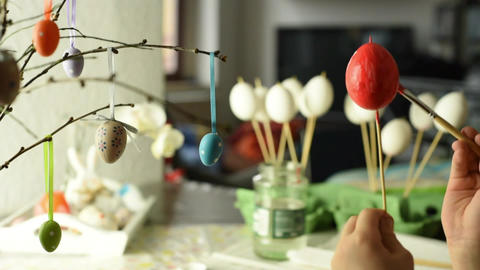 Young child painting easter eggs