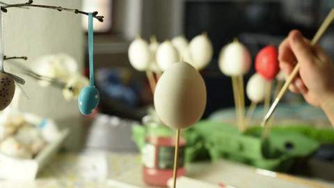 Young child painting easter eggs