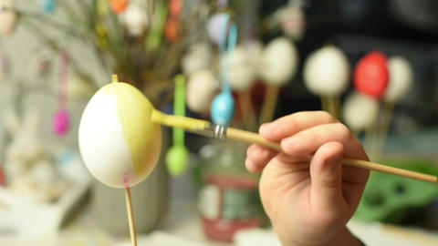 Young child painting easter eggs