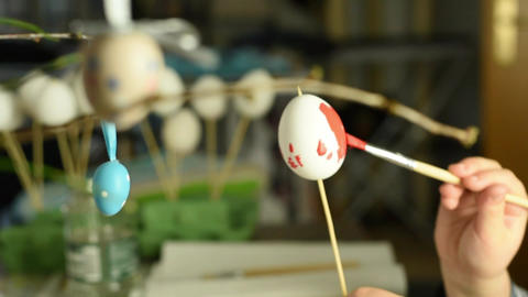 Young child painting easter eggs