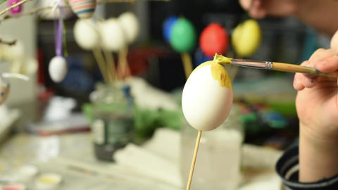 Young child painting easter eggs