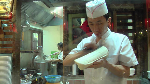 Chinese Chef Making Knife Cut Noodle
