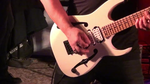 Guitar player on stage at a concert rocking the audience