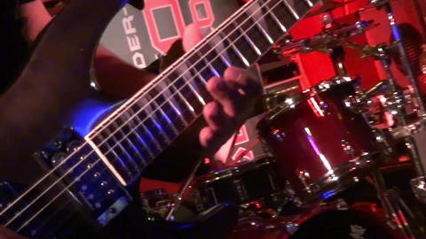 bass guitar in live action at a concert - rack focus - close up