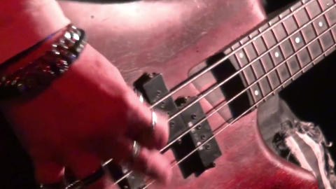 bass guitar in live action at a concert - rack focus - close up