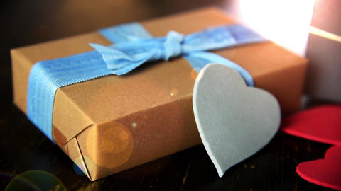 gift boxes with paper hearts on wood table close up