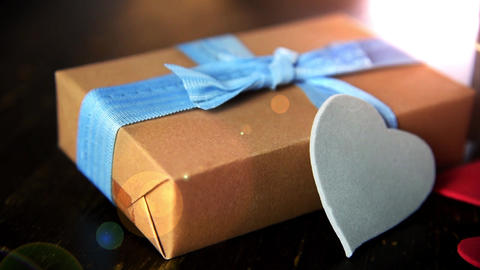 gift boxes with paper hearts on wood table close up