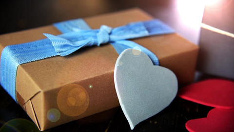 gift boxes with paper hearts on wood table close up