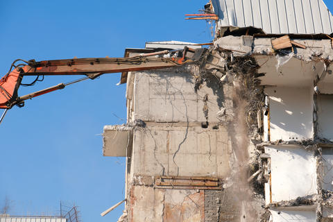 Building demolition with hydraulic excavator
